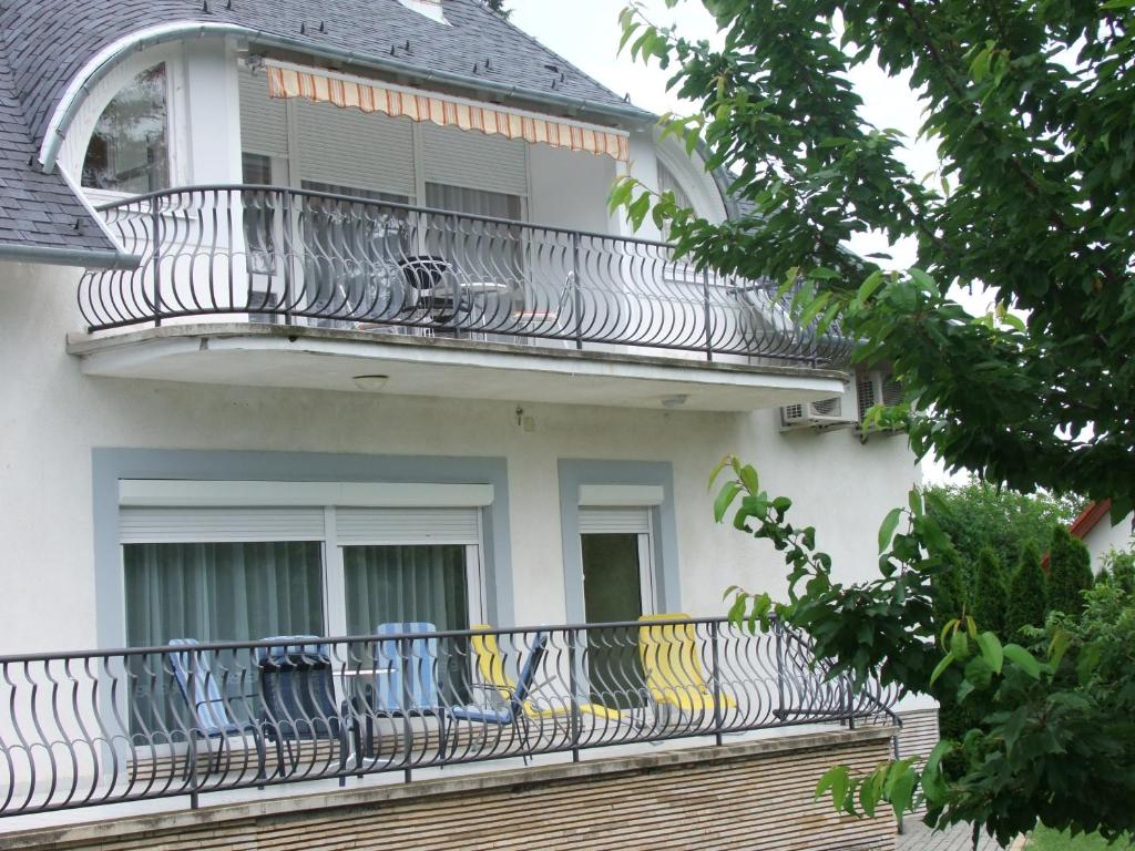 a balcony on the side of a house at Levente Apartman in Balatongyörök