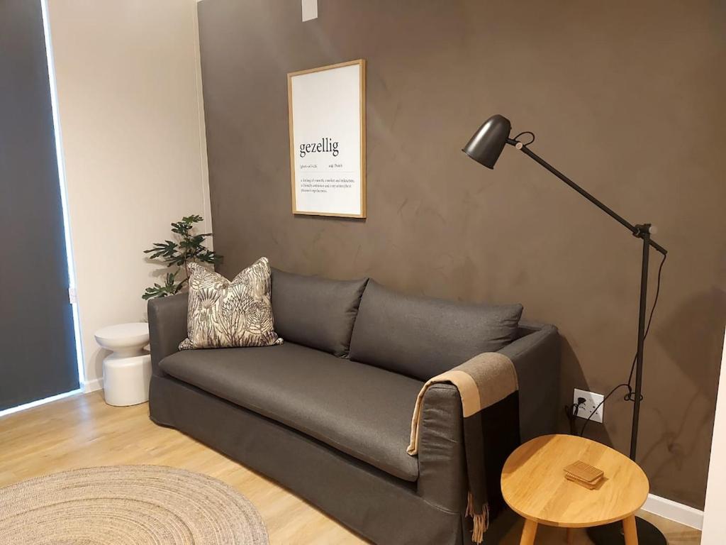 a living room with a couch and a lamp at 211 The Meadows in George