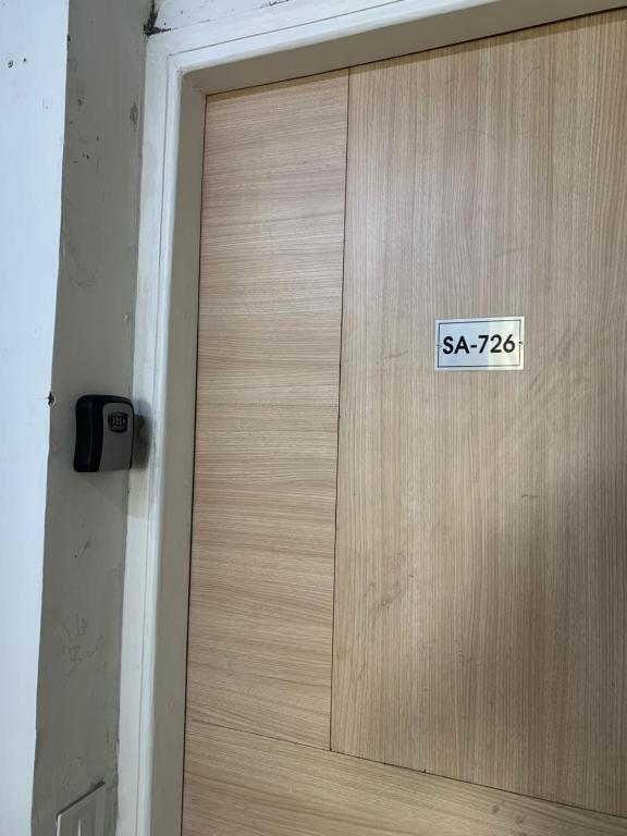 a wooden door with a sign on it at Sky heaven Bnb in Greater Noida