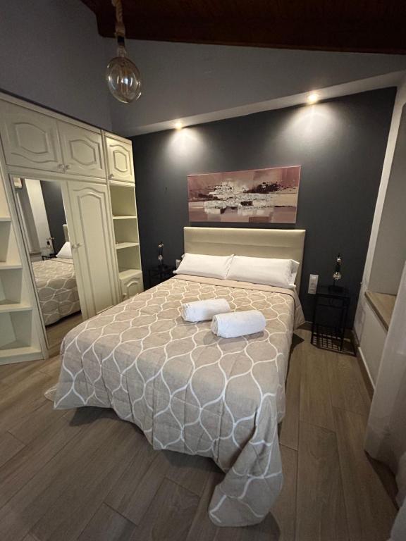 a bedroom with a bed with two towels on it at Apartamentos Turisticos Ilusiones 2 in Cazalla de la Sierra