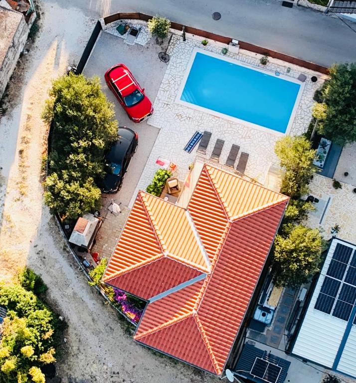an overhead view of a house with a swimming pool at Villa Marleku in Pakoštane