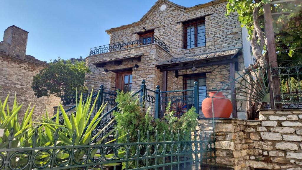 an old stone house with a black fence at Villa Michalis in Theológos