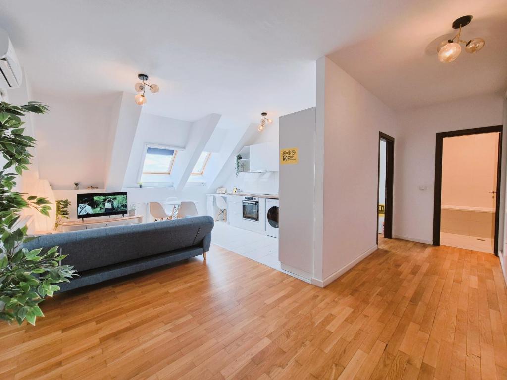 a living room with a couch and a kitchen at Bucharest Central DD Apartment in Bucharest