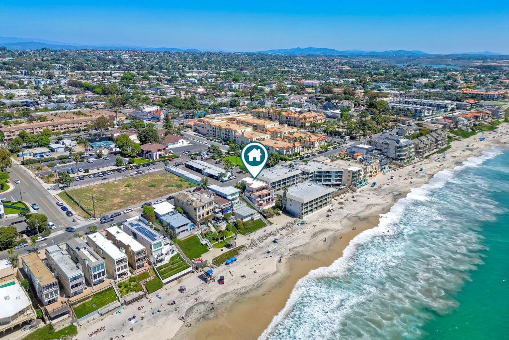 an aerial view of a beach with people and the ocean at Exclusive Beachfront Duplex in Carlsbad Village Ocean Views, Sleeps 9 in Carlsbad