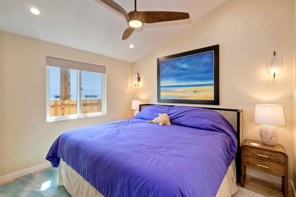 1 dormitorio con 1 cama con edredón morado en Luxe 1BR Near Beach & Pier, AC, Walk to Dining, en Oceanside