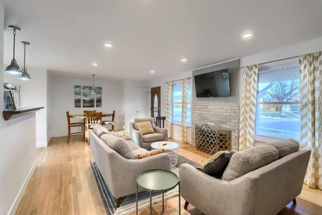 a living room with two couches and a fireplace at Mid-mod Home 3 Baths 2 Living Rms Yard in Centennial