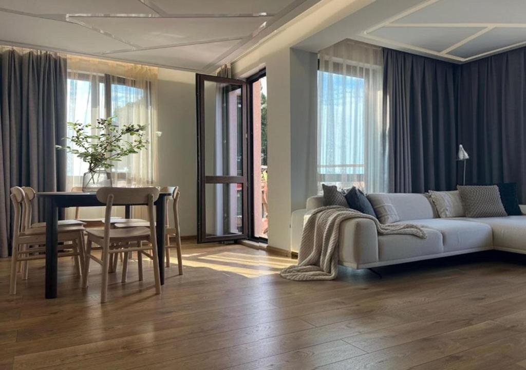 a living room with a couch and a table at Helen & Friends 3 bedrooms in Balchik