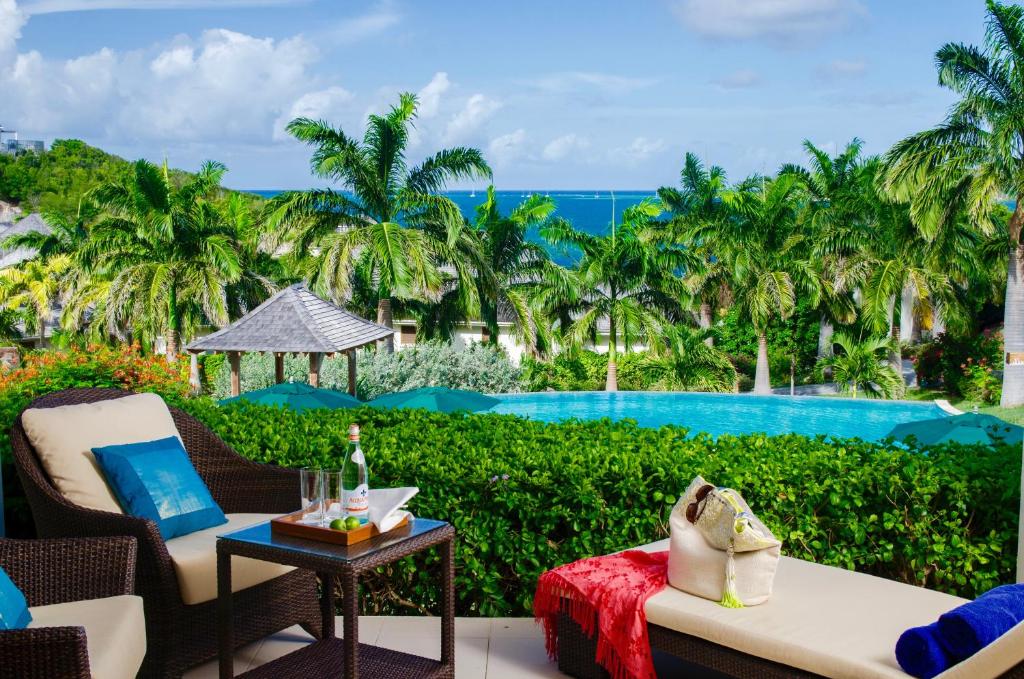 a resort patio with a view of a pool at Residences at Nonsuch Bay Antigua - Room Only - Self Catering in Saint Philips