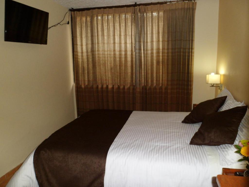 Postel nebo postele na pokoji v ubytování Hotel Tuvalu