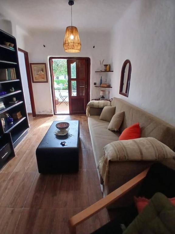 a living room with a couch and a table at Coastal Elegance in Oulad Akkou