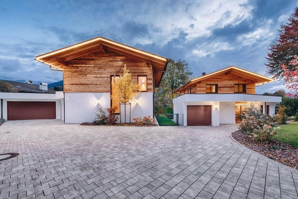 a house with a stone driveway in front at Riverside Chalet Dreitorspitz in Garmisch-Partenkirchen