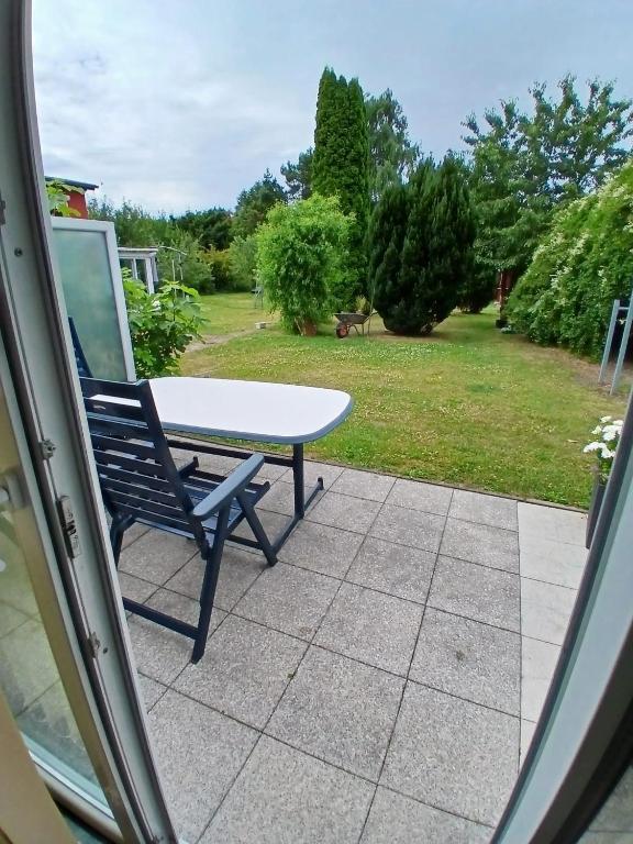 a table and a chair sitting on a patio at Bungalow in Kühlungsborn in Kühlungsborn