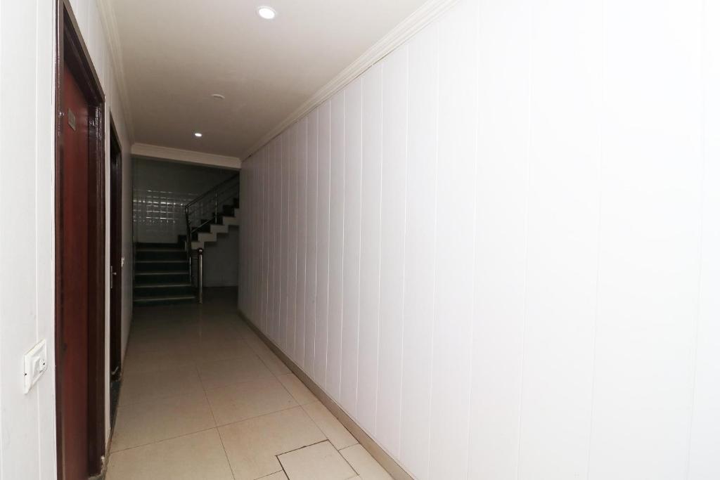 an empty hallway with a staircase in a house at Hotel O Gayatri Palace in Tājganj