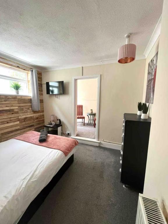 a bedroom with a bed and a table and a window at 106 Brynmill - Room 3 in Sketty