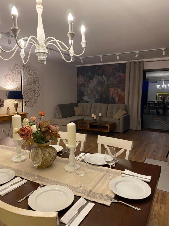 a dining room with a table with plates and candles at Moja bajka in Zamość