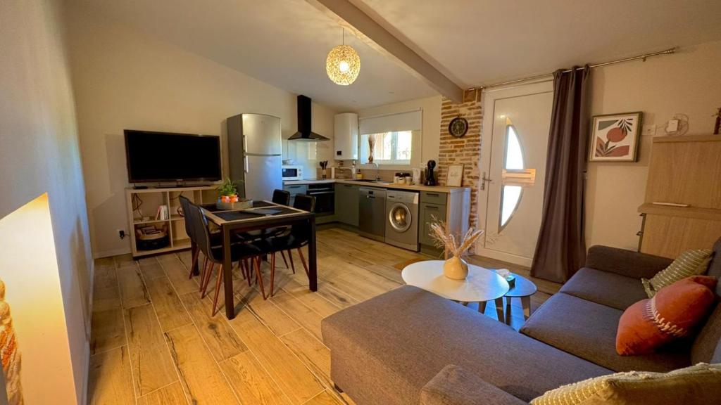 a living room with a couch and a table at Le Gîte de Cousal in Esperce