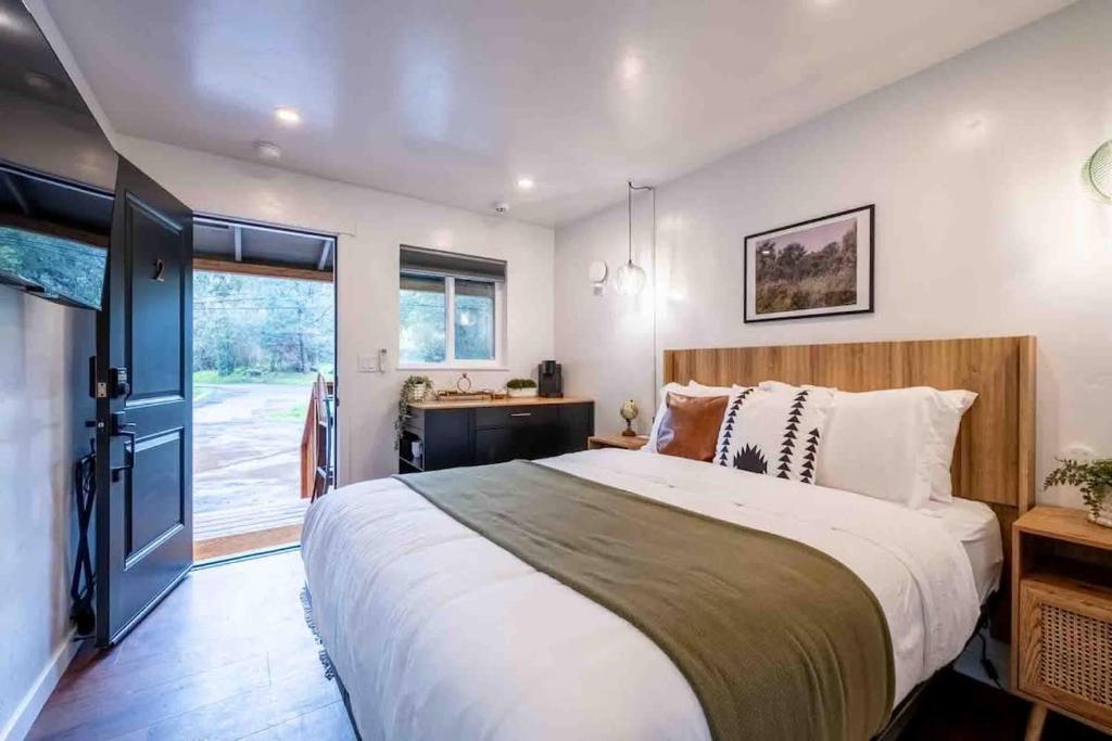 a bedroom with a large bed and a window at Columbia Cabins Cabin 2 in Sonora