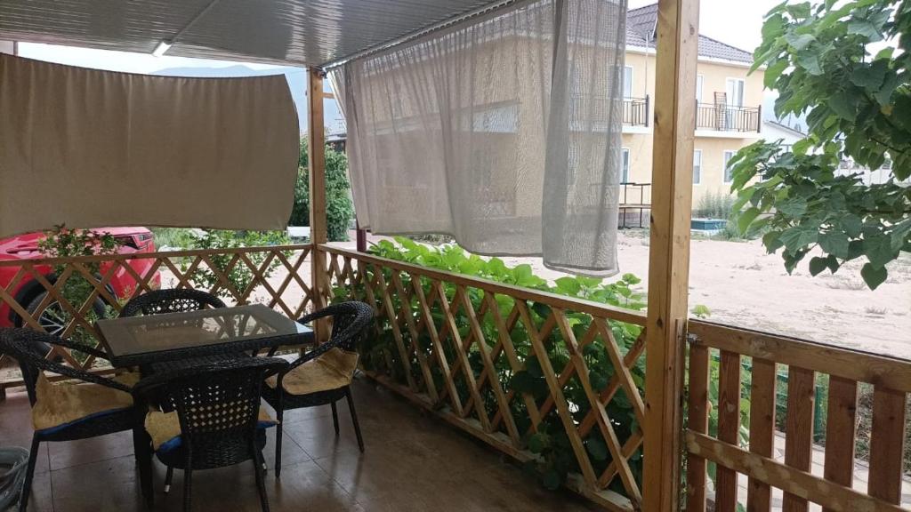 a balcony with a table with a laptop on it at Ысык-Кол Чок-Тал in Chok-Tal
