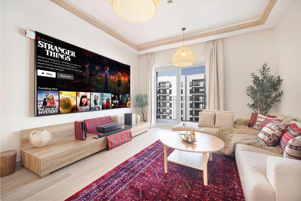 a living room with a couch and a table at 1BR Yas Marina Apartment - Near Ferrari World in Abu Dhabi