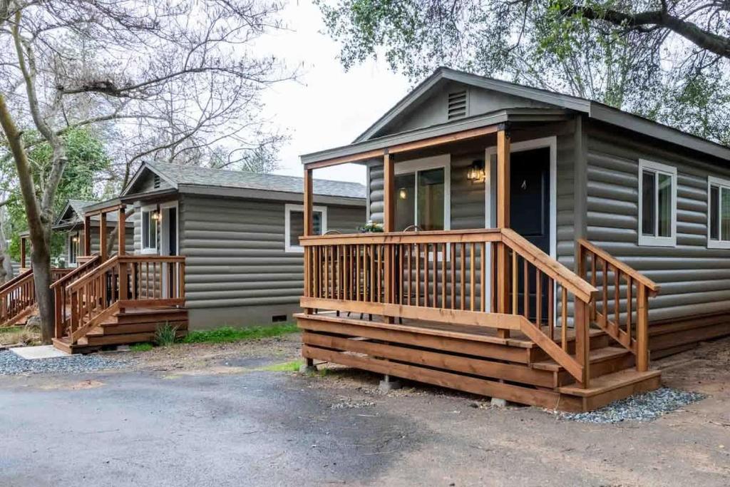 a log cabin with a porch and a deck at Columbia Cabins Cabin 4 in Sonora