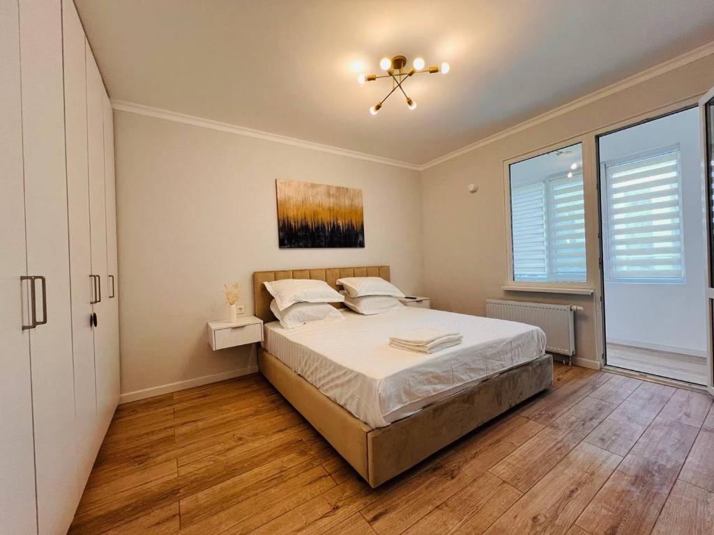 a bedroom with a bed and a ceiling fan at Good mood in Astana
