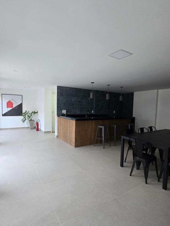 een kamer met een tafel en stoelen en een keuken bij Home Easy Flat in Volta Redonda