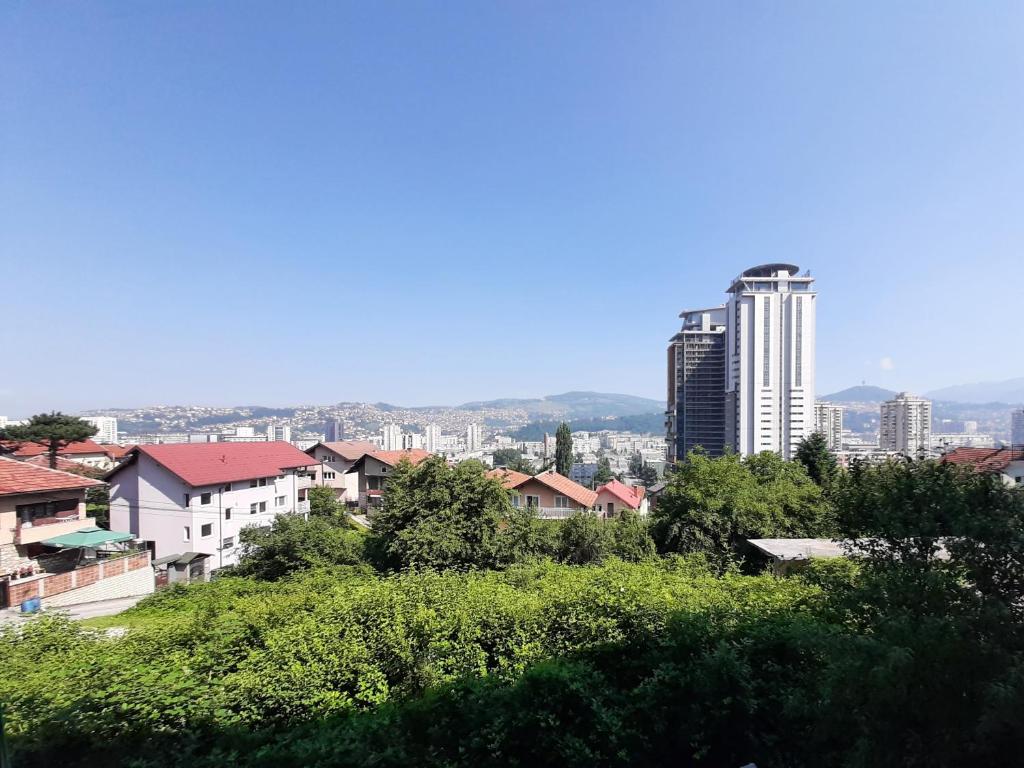 a view of a city with tall buildings and trees at Golden View Apartment in Sarajevo