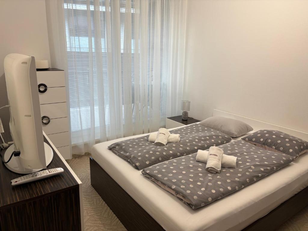 a bedroom with a large bed with towels on it at Donovaly Triangel A10 in Mistríky