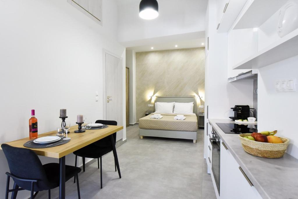 a room with a kitchen and a bedroom with a bed at DS Elegant Apartment in Ermoupoli