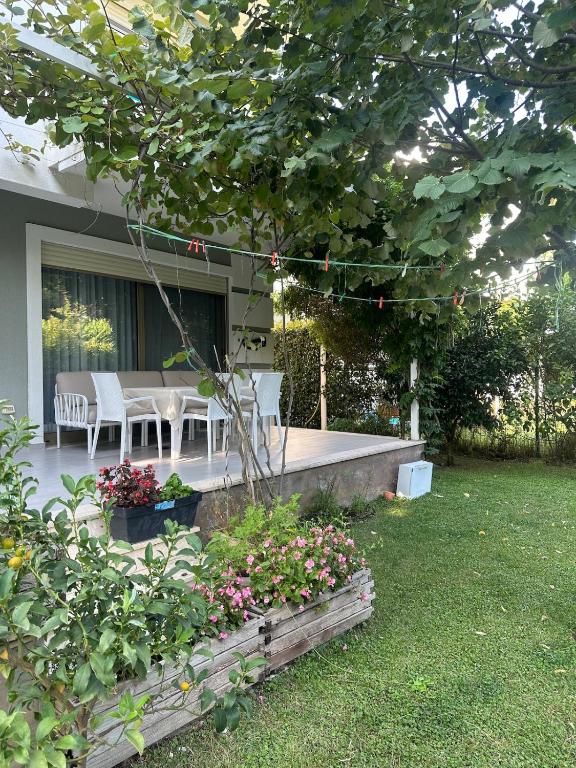 a patio with a table and chairs in a yard at Villa Amalia Perla Resort in Draç