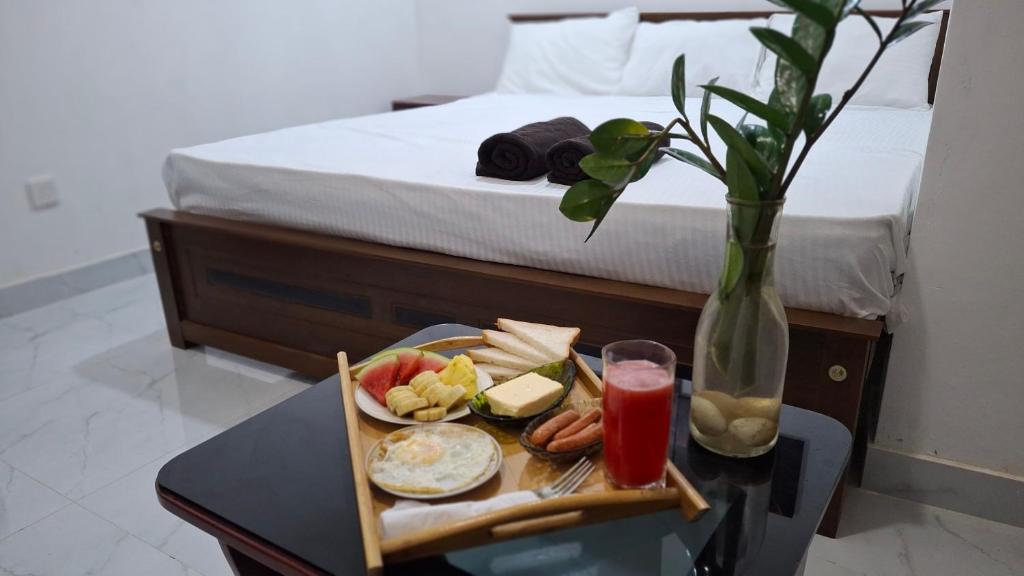 a tray of food on a table next to a bed at Kandy Jungle Border in Kandy