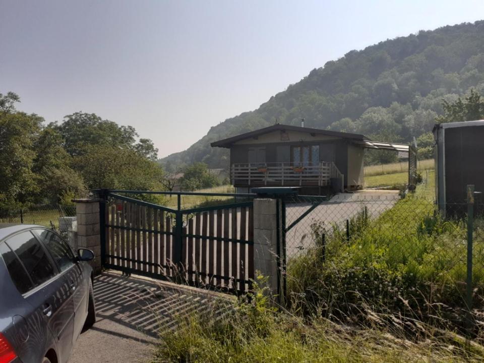 a car parked in front of a house with a gate at Chalet a la montagne in Cornod