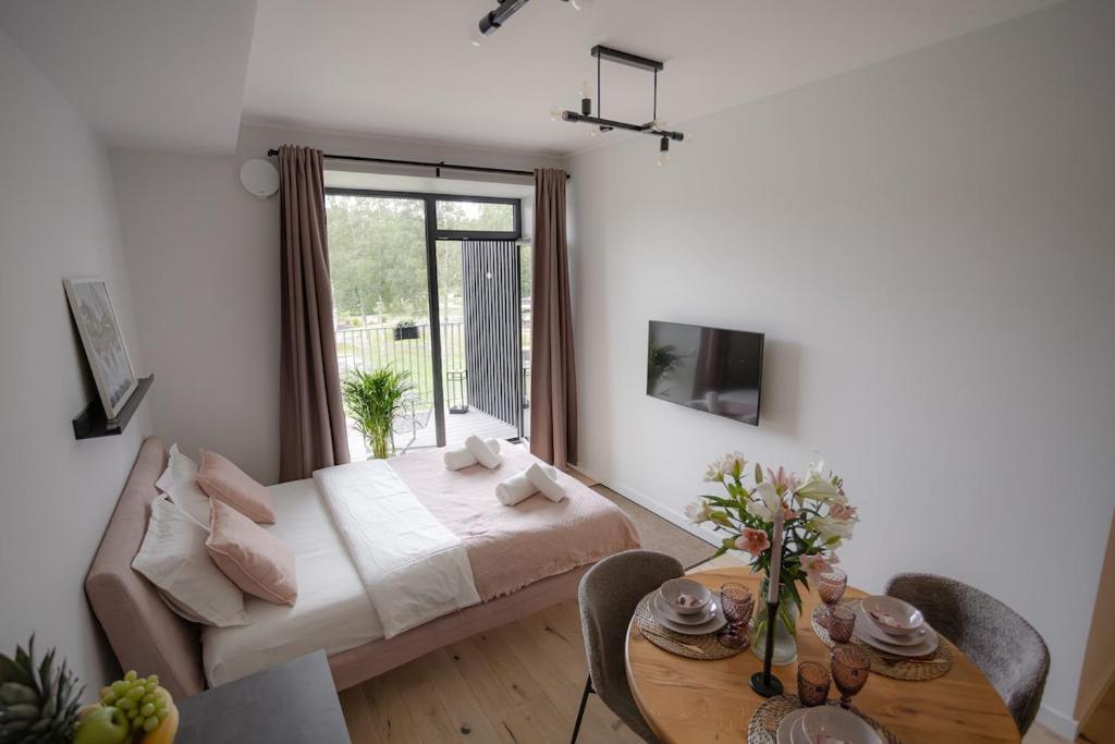 una camera da letto con un letto e un tavolo con una sala da pranzo di La Tereza Apartments a Ķesterciems