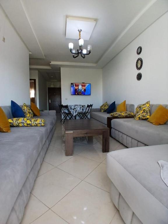 a living room with couches and a coffee table at Azure Luxe Retreat in Martil