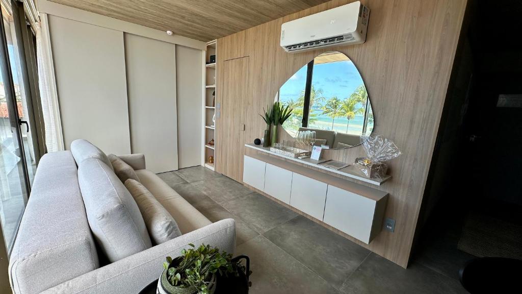 a living room with a couch and a sink at Studio Luxo Frente Mar NT 311 in Maceió