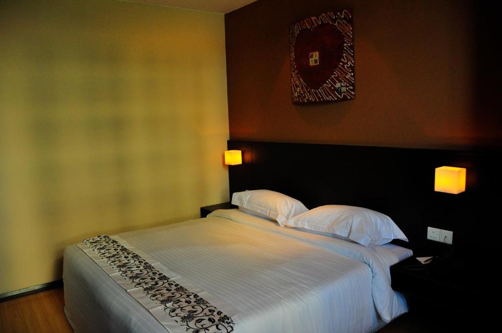 Postel nebo postele na pokoji v ubytování Tat Place Hotel