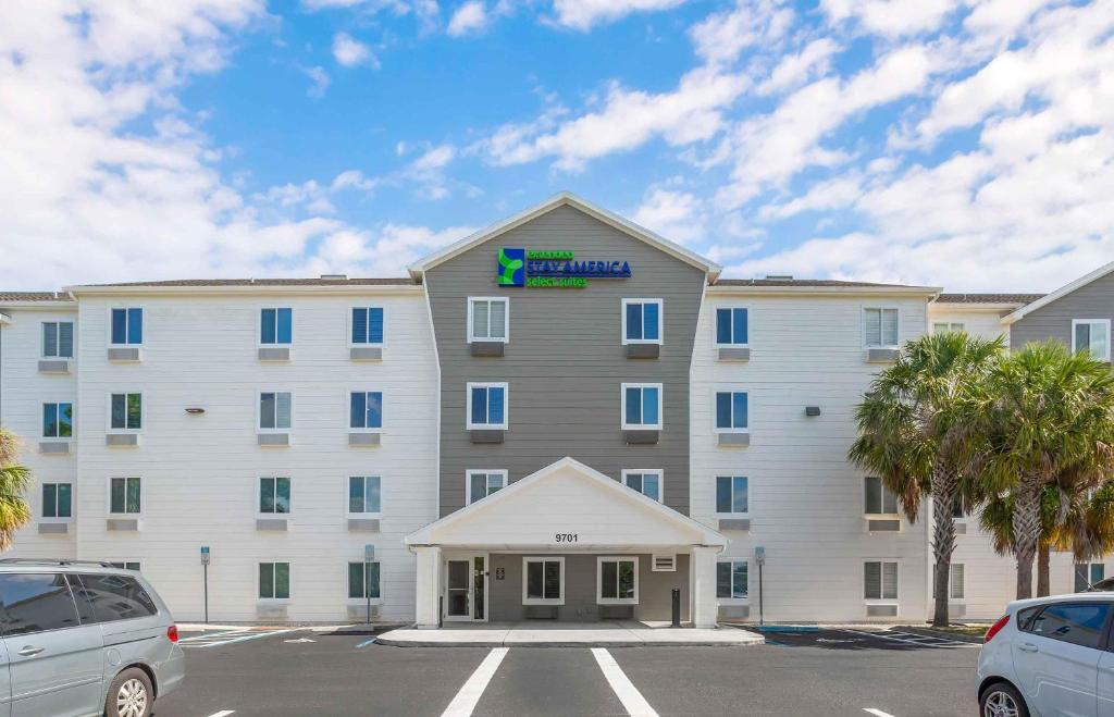a large white building with a sign on it at Extended Stay America Select Suites - Fort Myers - Northeast in Fort Myers