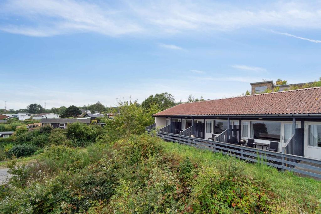 a house with a red roof on top of a field at Lovely Holiday Apartment Consumption Included in Allinge