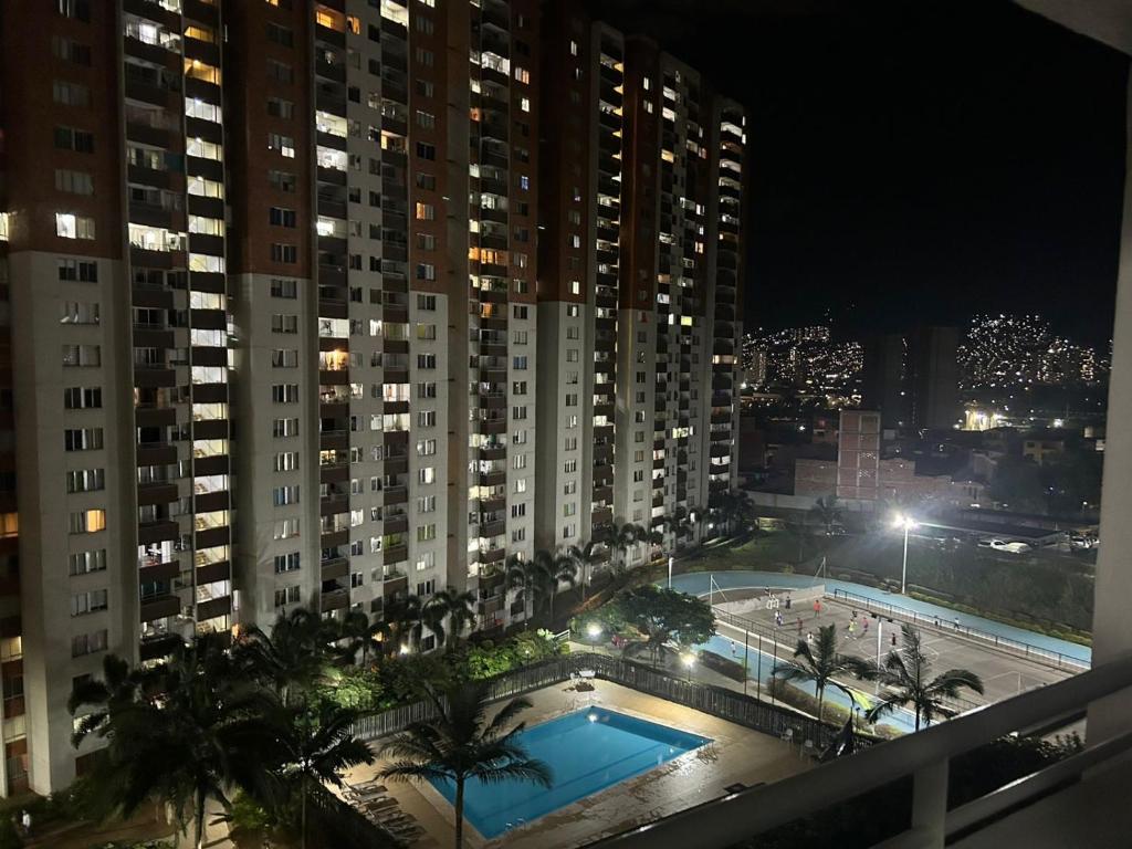 a view of a pool from a balcony at night at Luxurious Stay con 3 habitaciones in Bello