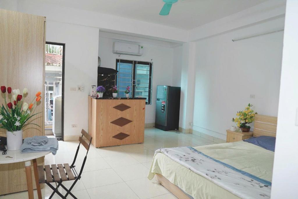 a bedroom with a bed and a desk and a table at Phương Anh 303DM2 in Hanoi