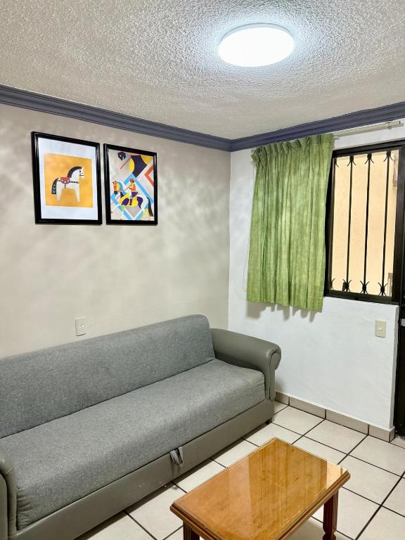 a living room with a couch and a table at Departamento Independiente in Morelia