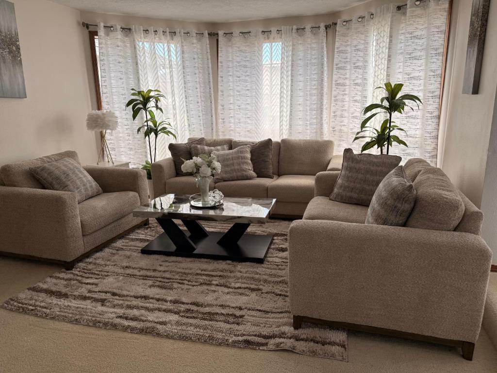 a living room with two couches and a coffee table at Serene home in Gresham