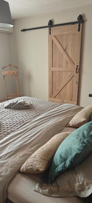 a bedroom with a bed with a wooden door at holiday home Zonnestraal in Zonhoven