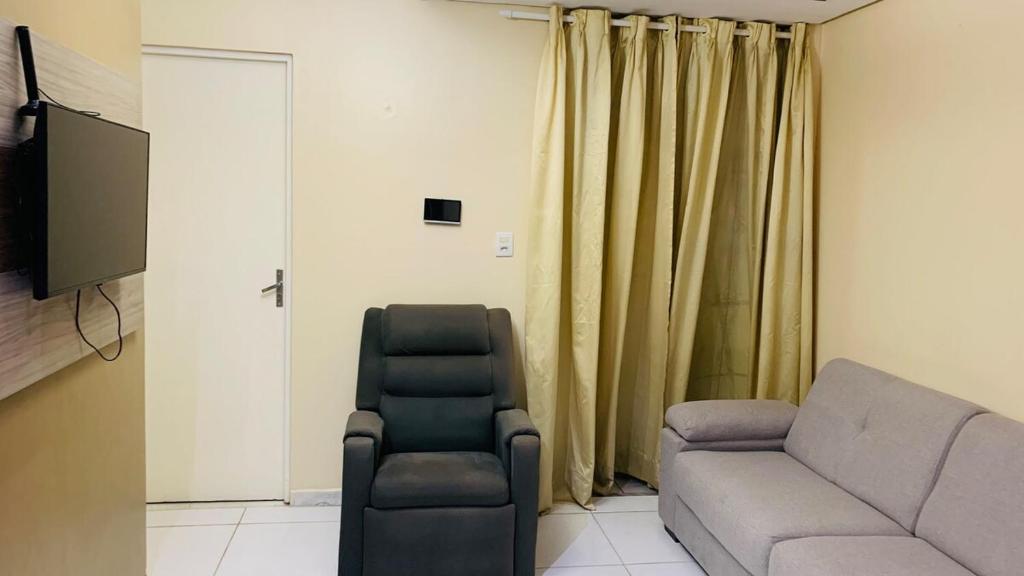 a living room with a couch and a chair at GUARÁS - Complete & excellent locationCOP 30 in Belém