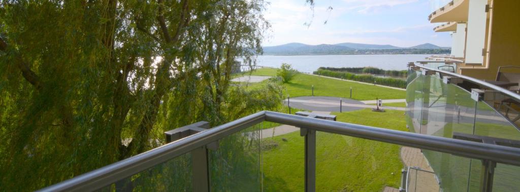 a balcony with a view of a body of water at Laura apartman Velence in Velence