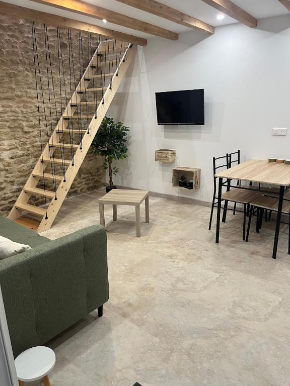 a living room with a couch and a tv and tables at L escale des dhuys in Soulaines-Dhuys