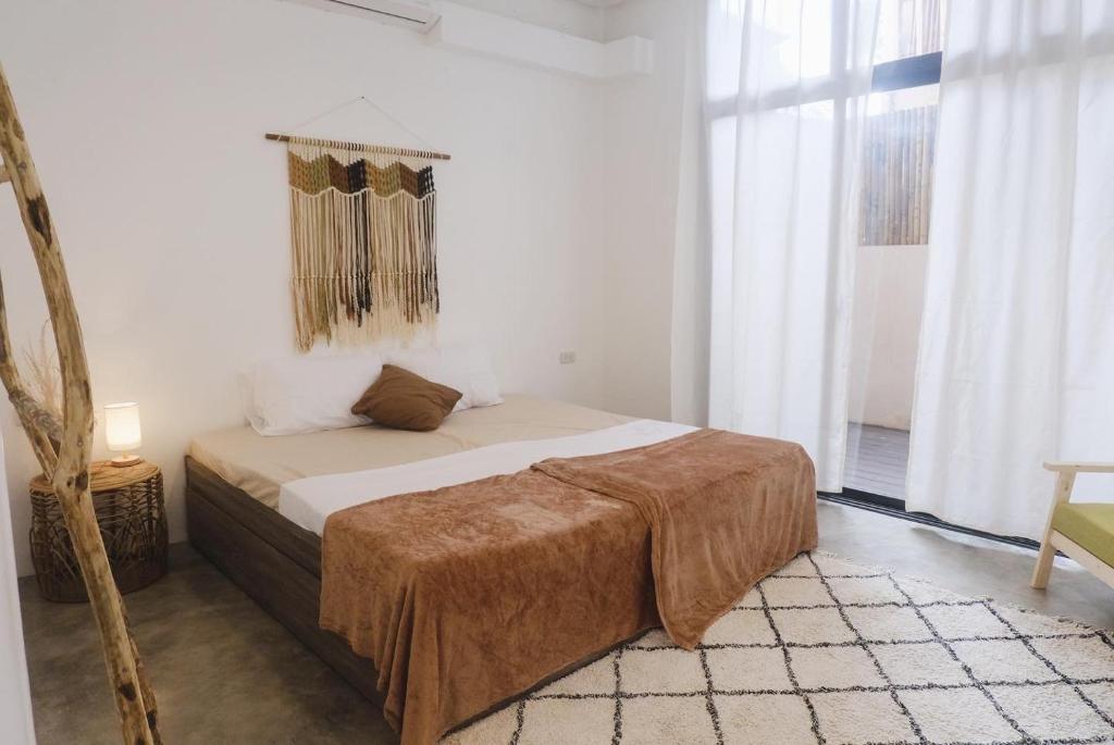 Postel nebo postele na pokoji v ubytování Meraki Siargao Resort