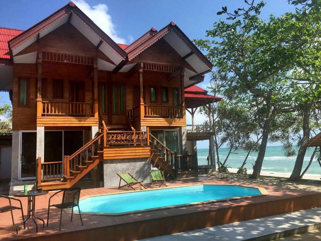 a house with a pool in front of it at Phuphat Beach in Khanom