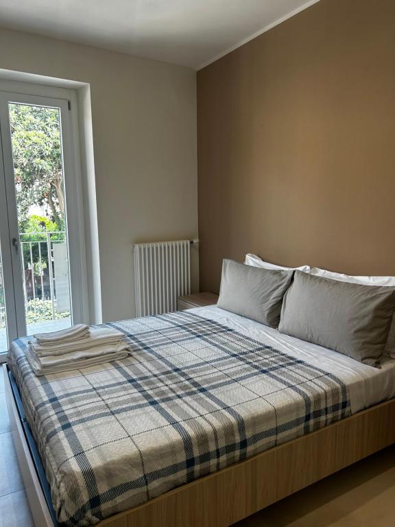 a bedroom with a bed with a plaid blanket at San Pietro Pontremoli in Pontremoli