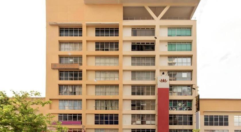 a tall building with a clock in front of it at OYO 90429 Hotel Narasindo in Kuala Lumpur